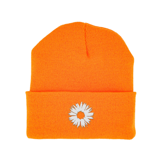 Orange beanie with a white flower design on a white background